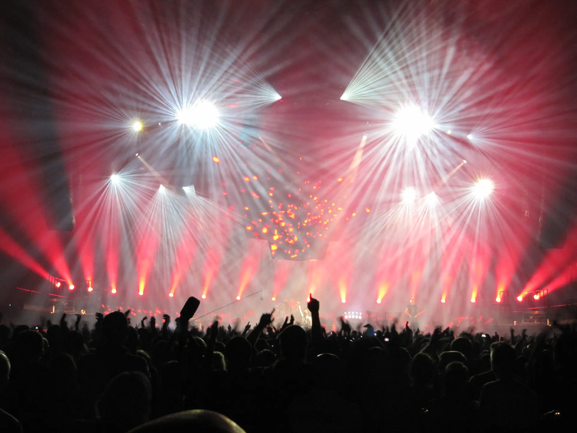 J&C Joel is a leading fabric and mechanical solutions provider in the UK and Middle East. The company offers high-quality fabric products, stage curtains, drapery, and advanced mechanical systems for theatres, events, and architectural spaces. This image shows an example of concert touring with a crowd of people with their arms up.