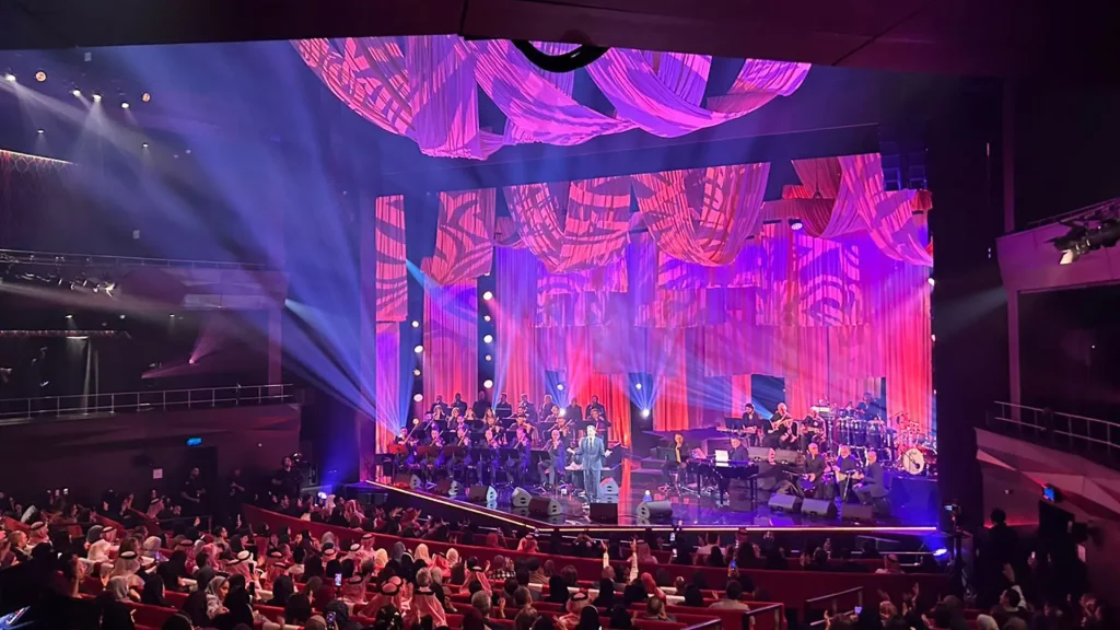 A performance by Kadim Al Sahir taking place within the theatre of the King Abdulaziz Centre for World Culture, also known as Ithra.