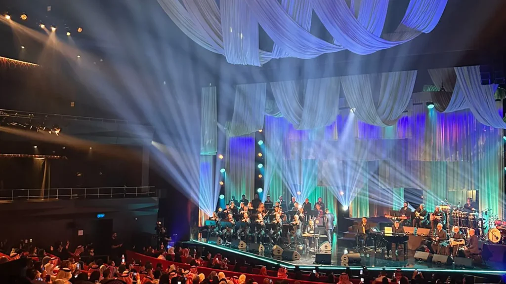 A performance by Kadim Al Sahir taking place within the theatre of the King Abdulaziz Centre for World Culture, also known as Ithra.