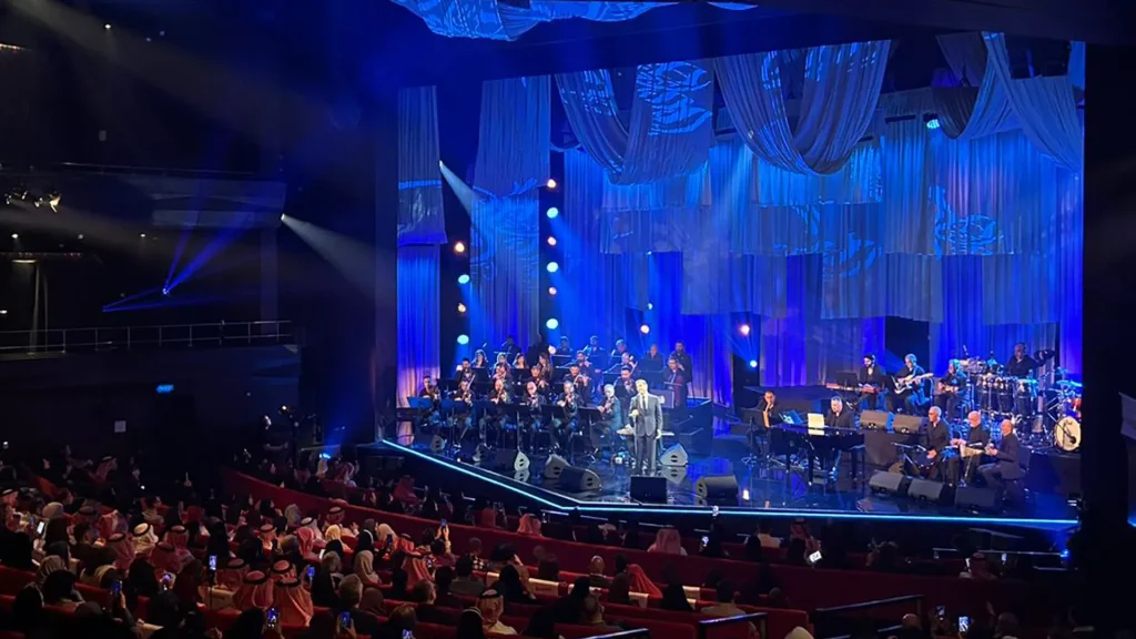 A performance by Kadim Al Sahir taking place within the theatre of the King Abdulaziz Centre for World Culture, also known as Ithra.