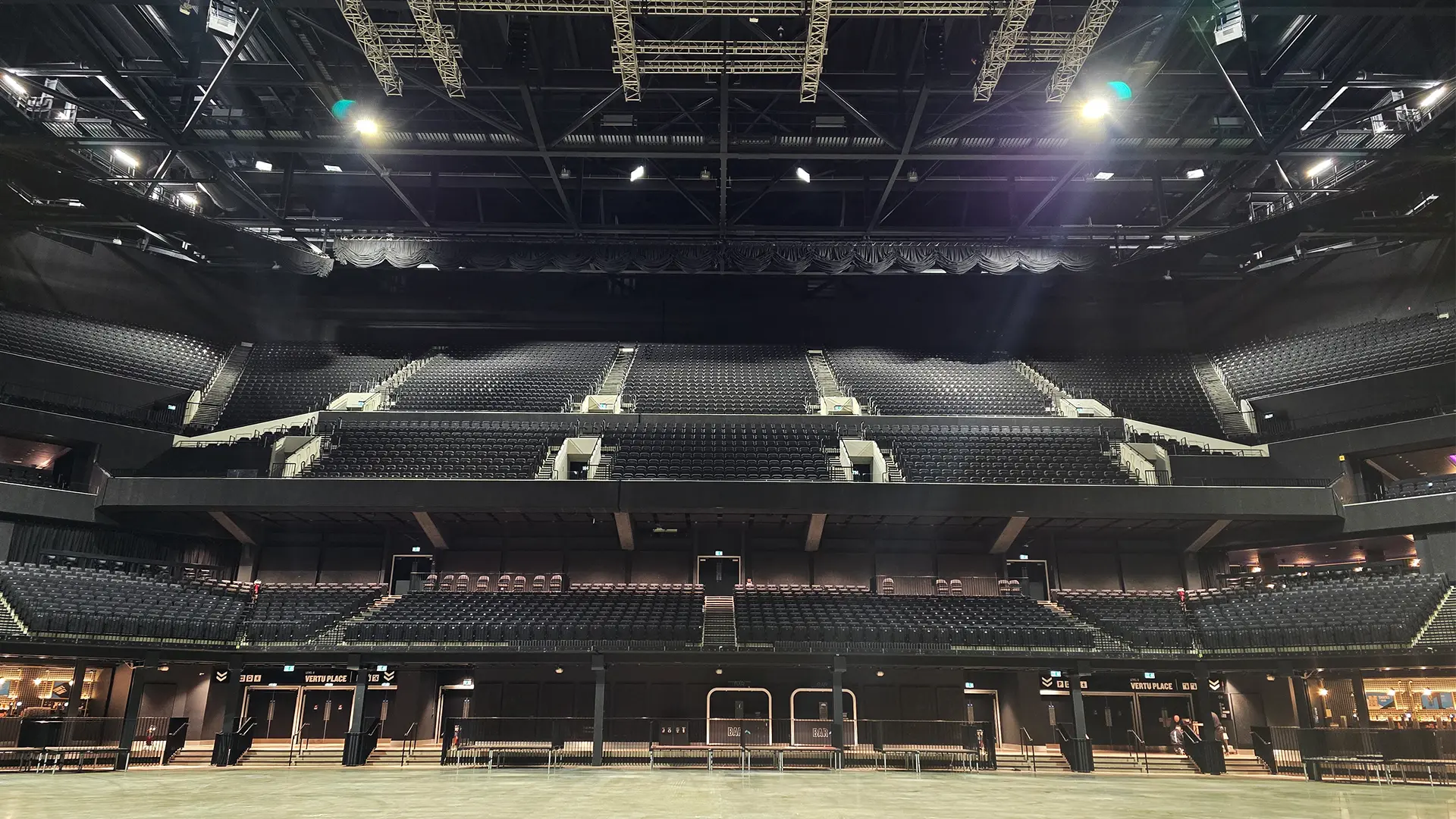 A vertical drape raise shown with the drapes raised to the highest in an arena setting.